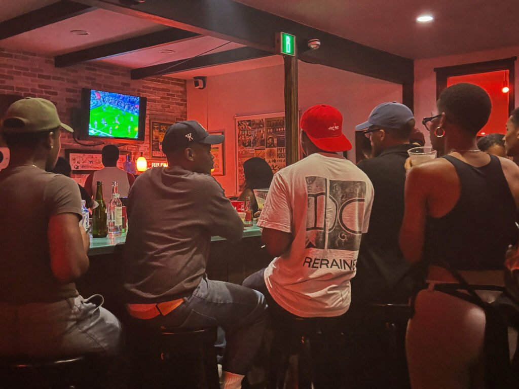 Guests at the bar watching a game